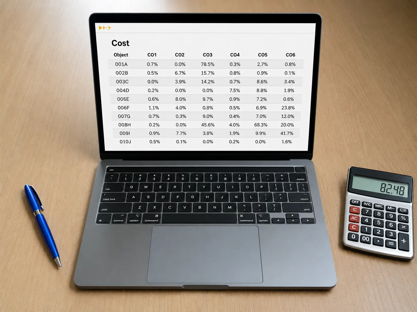 Laptop showing cost data table alongside a calculator